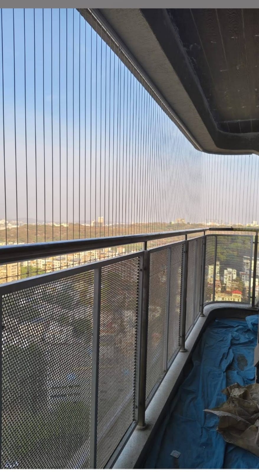 Long balcony invisible grill installation with wide city exposure